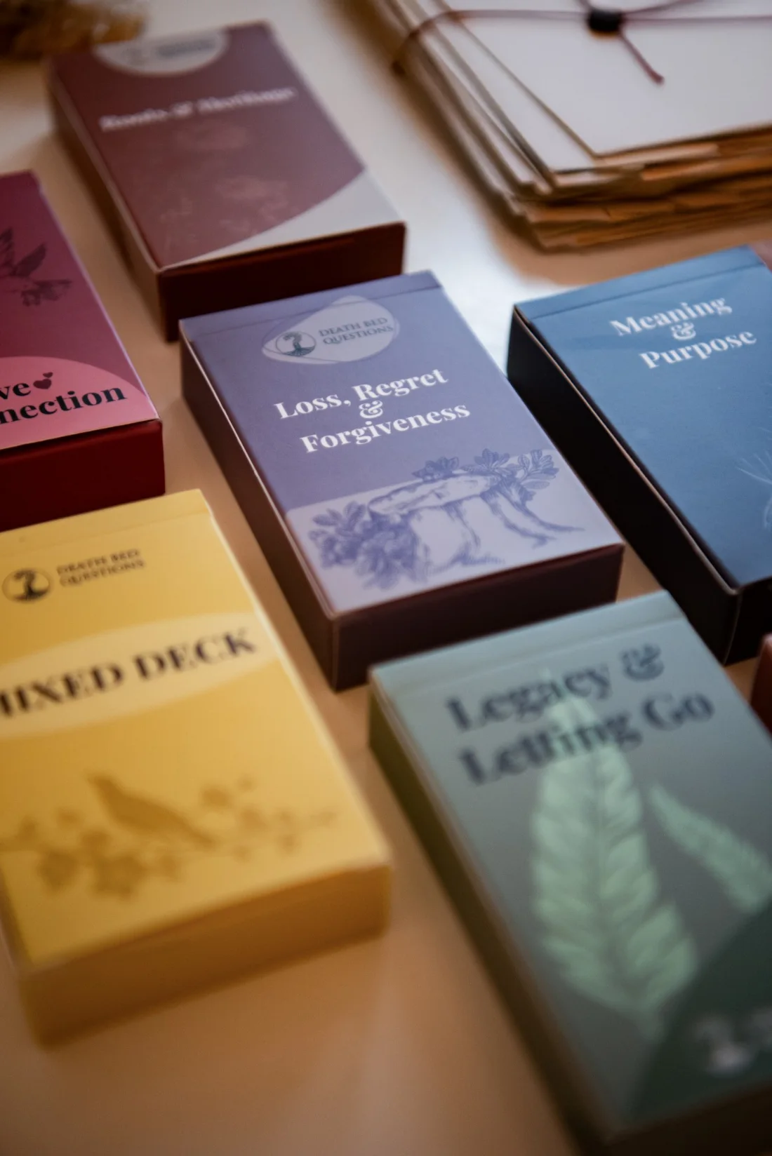 Death Bed Questions decks laid out on a table
